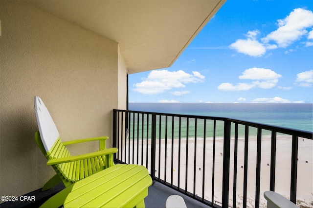 balcony with a beach view and a water view