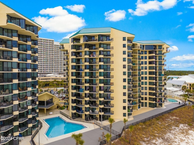 view of building exterior with a community pool