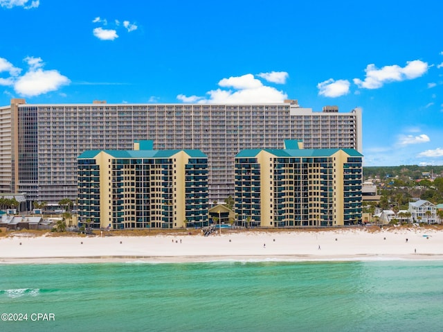 exterior space featuring a water view and a view of the beach