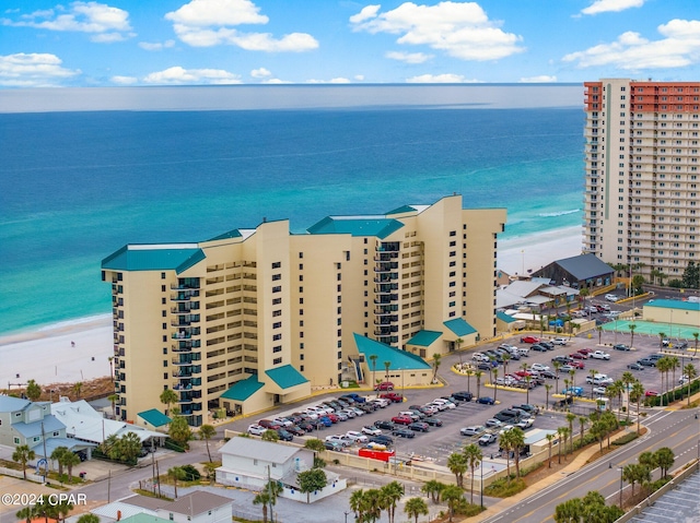 drone / aerial view featuring a beach view and a water view