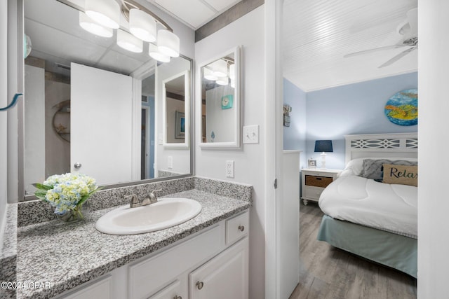 bathroom featuring hardwood / wood-style floors, oversized vanity, and ceiling fan