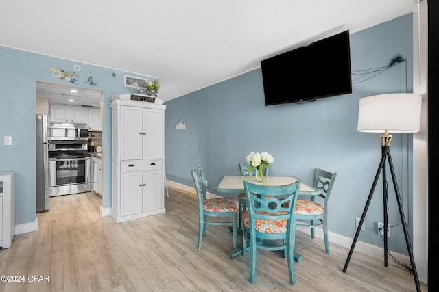 dining area with light hardwood / wood-style flooring