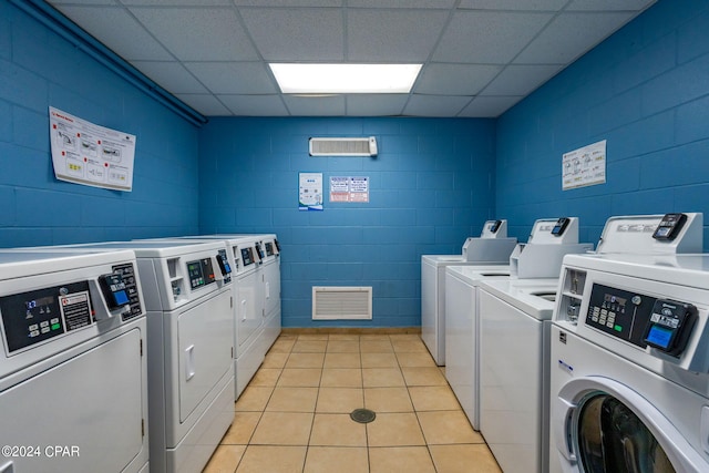 washroom with washer and clothes dryer and light tile floors