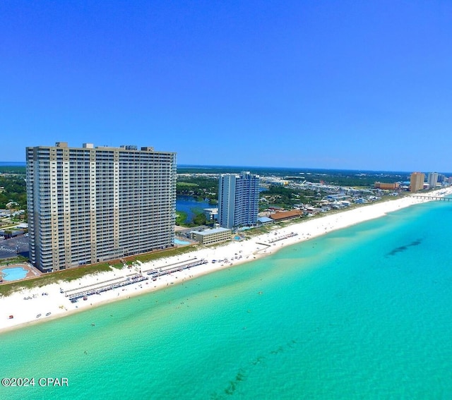 birds eye view of property featuring a beach view and a water view