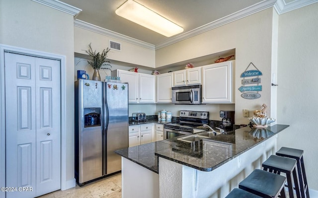 kitchen with light tile floors, kitchen peninsula, crown molding, and stainless steel appliances