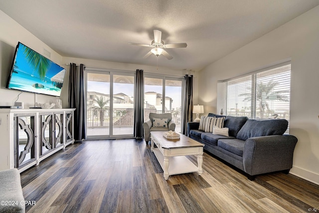 living room with dark hardwood / wood-style floors and ceiling fan