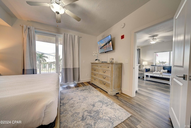 bedroom featuring wood-type flooring, ceiling fan, and access to outside