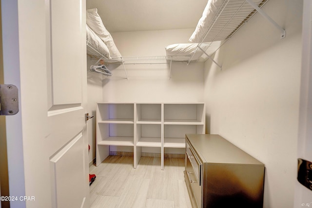 spacious closet with light tile floors