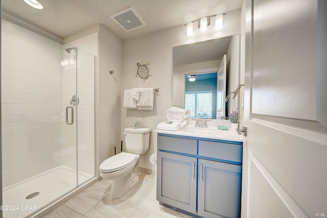 bathroom featuring tile flooring, an enclosed shower, toilet, and large vanity