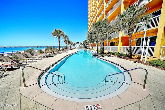 view of pool featuring a water view