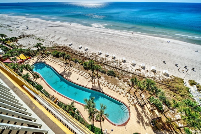 drone / aerial view featuring a water view and a beach view