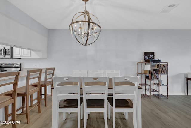 dining area with a chandelier and light wood-type flooring