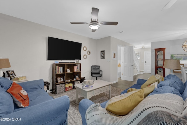 living room with ceiling fan and light hardwood / wood-style flooring