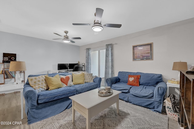 living room featuring ceiling fan and light wood-type flooring