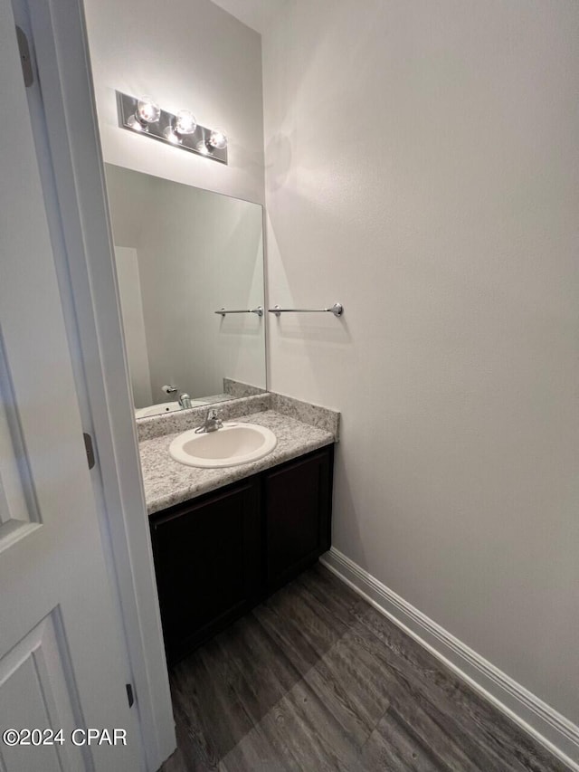 bathroom with vanity and hardwood / wood-style flooring