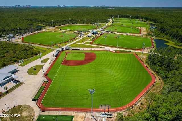 birds eye view of property featuring a wooded view and a water view