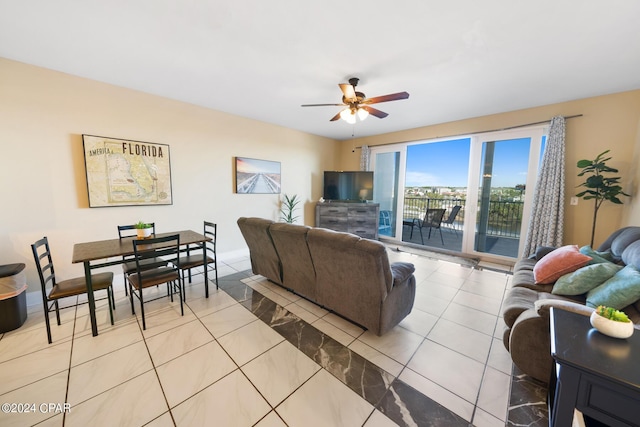 tiled living room with a ceiling fan