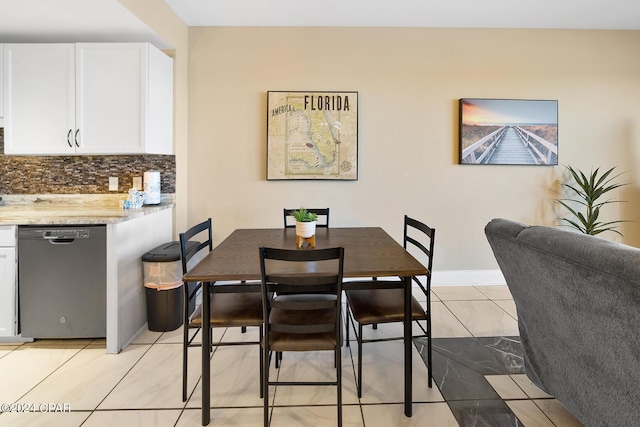 dining space with light tile patterned flooring and baseboards