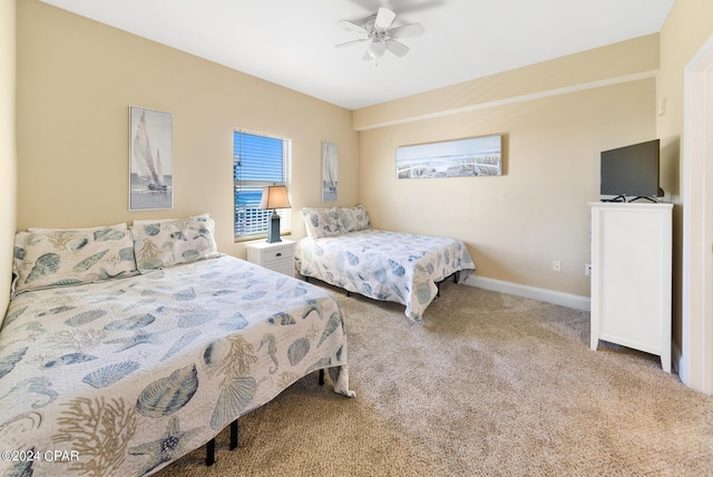 carpeted bedroom featuring ceiling fan and baseboards