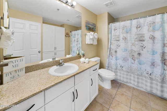 full bathroom with tile floors, toilet, vanity, and shower / tub combo with curtain