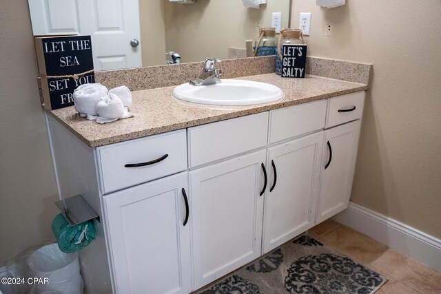 bathroom with toilet, tile flooring, and vanity