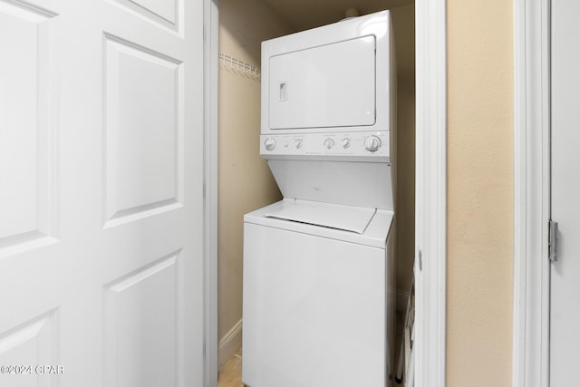 washroom with laundry area and stacked washing maching and dryer