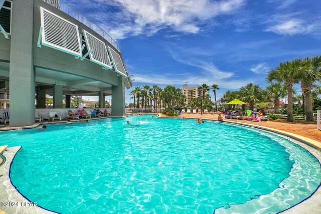 view of pool with pool water feature and a patio