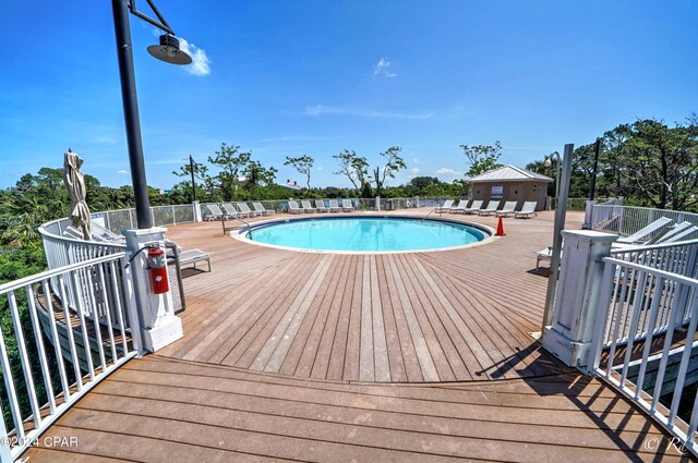 view of pool with a patio and a water view