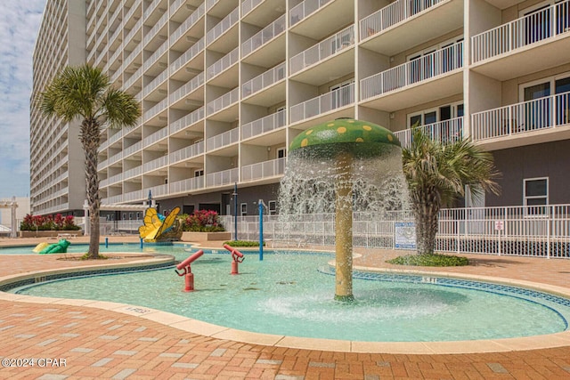 view of swimming pool featuring fence