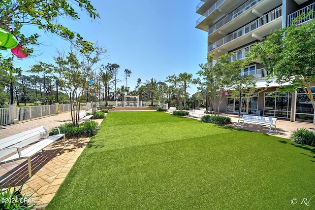 surrounding community with a lawn and a patio area