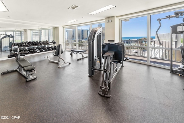 gym with a wall of windows and visible vents