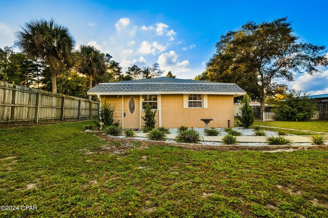 exterior space with a lawn and an outdoor structure