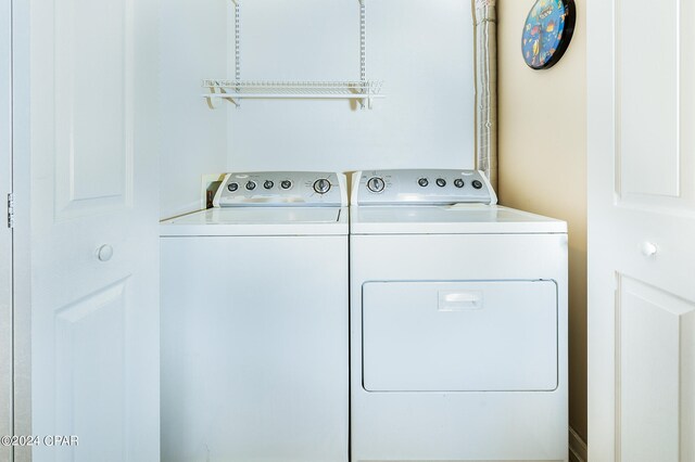 clothes washing area with washer and clothes dryer