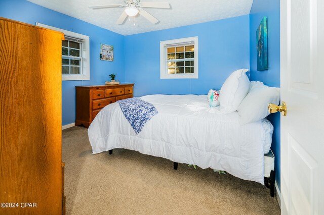 bedroom with ceiling fan and carpet