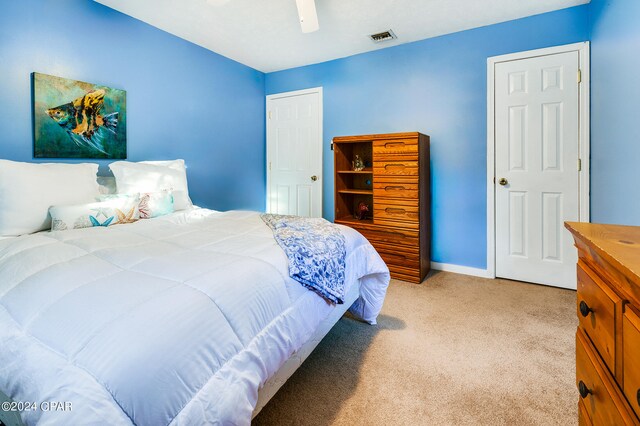 bedroom with ceiling fan and light carpet