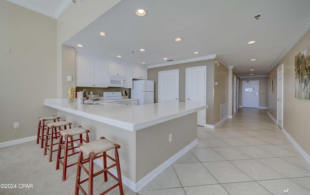 kitchen with recessed lighting, white appliances, a peninsula, and crown molding