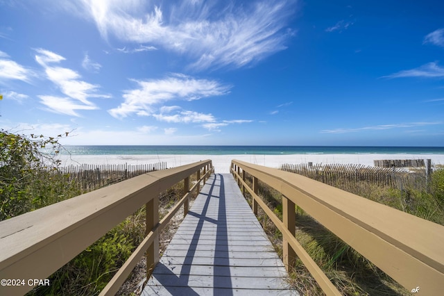 surrounding community with a beach view and a water view