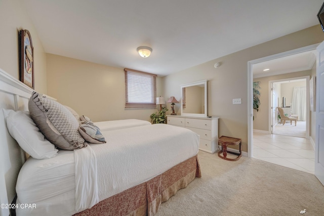 bedroom featuring light tile patterned floors, light carpet, and baseboards