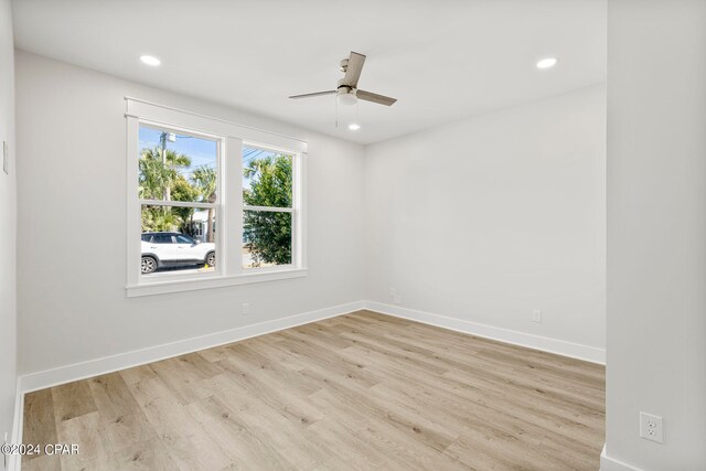 spare room with light hardwood / wood-style floors and ceiling fan