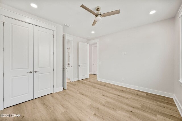 unfurnished bedroom with ceiling fan, a closet, and light hardwood / wood-style flooring