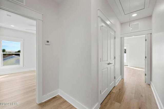 hallway with light hardwood / wood-style flooring