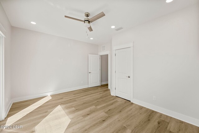 spare room featuring light hardwood / wood-style floors and ceiling fan