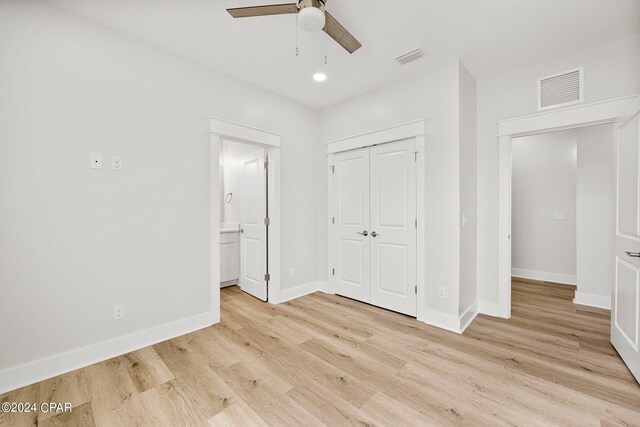 unfurnished bedroom with ceiling fan, light hardwood / wood-style floors, and a closet