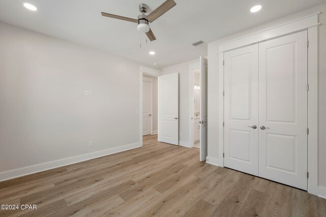 unfurnished bedroom featuring a closet, ceiling fan, and light hardwood / wood-style flooring