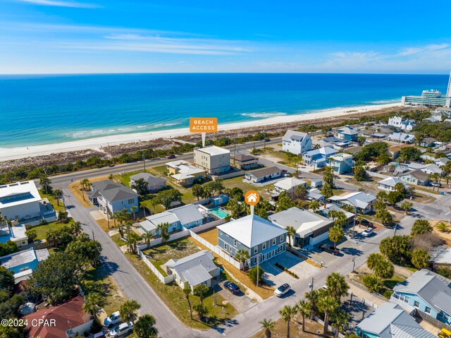 birds eye view of property with a beach view and a water view