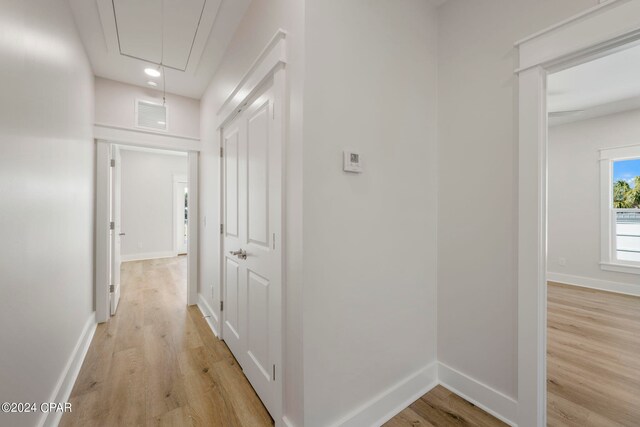 corridor with light wood-type flooring