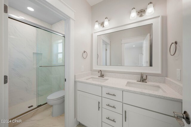 bathroom with toilet, oversized vanity, tile flooring, dual sinks, and an enclosed shower