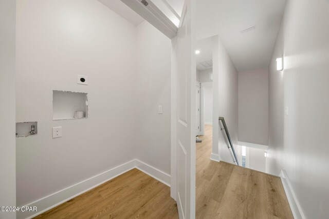 washroom with washer hookup, hookup for an electric dryer, and light wood-type flooring