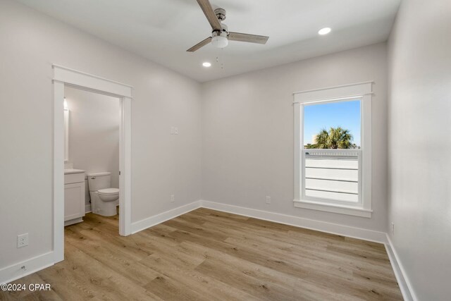 empty room with light hardwood / wood-style floors and ceiling fan