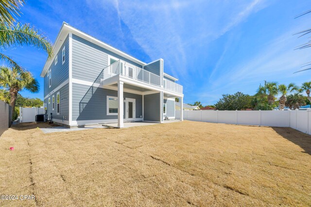 back of property with a patio and central AC